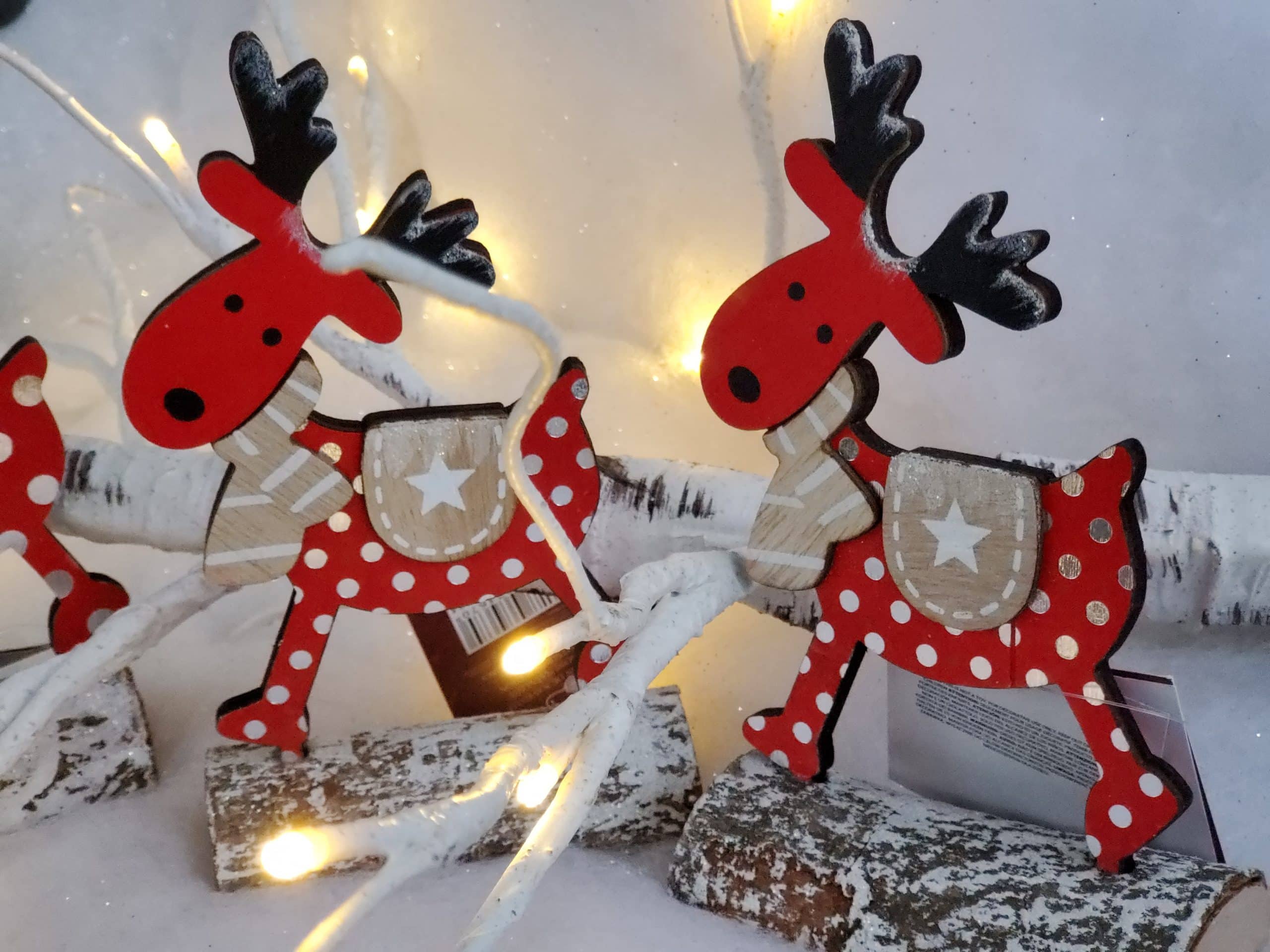 Wooden reindeer on log