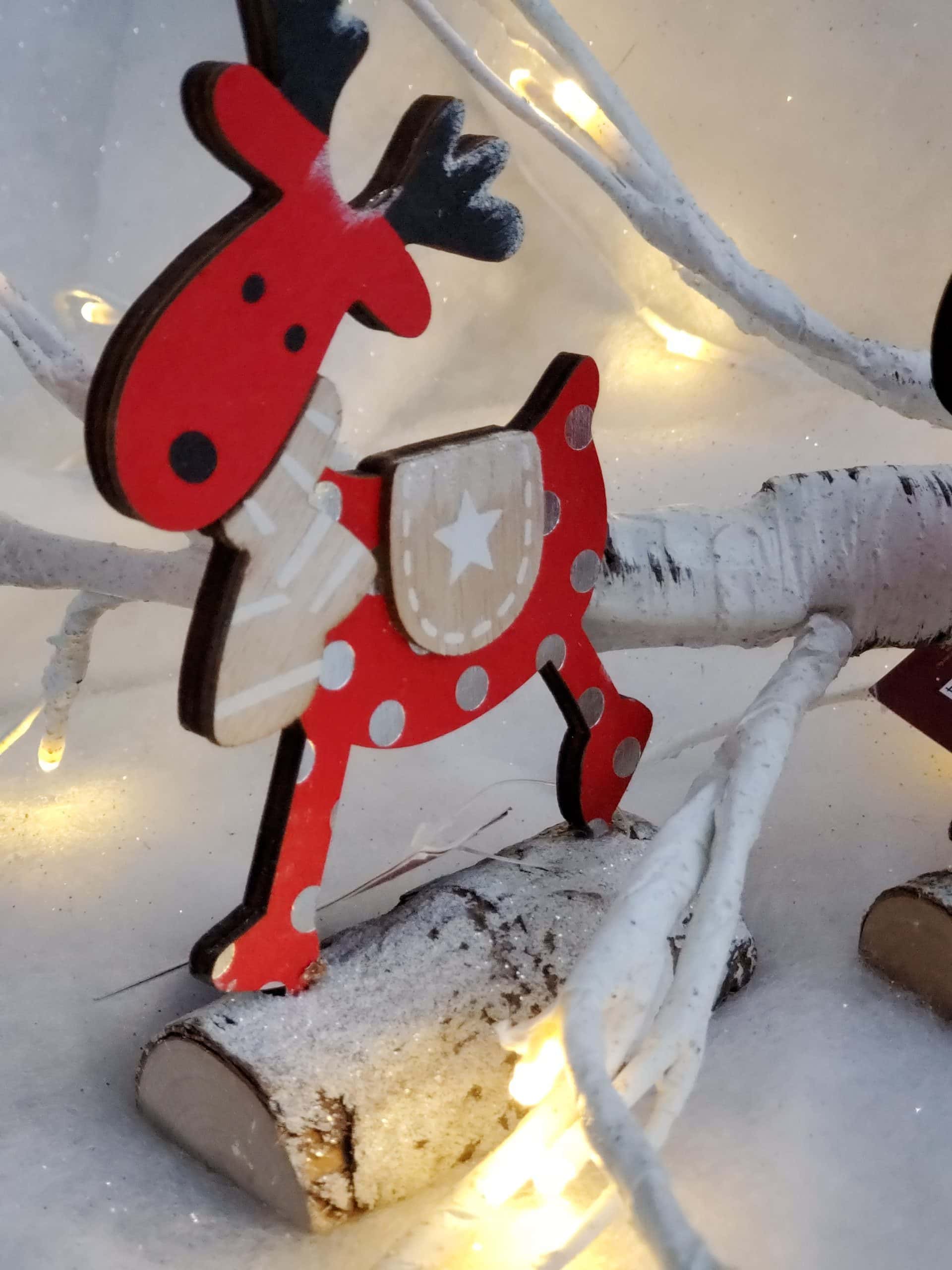 Wooden reindeer on log