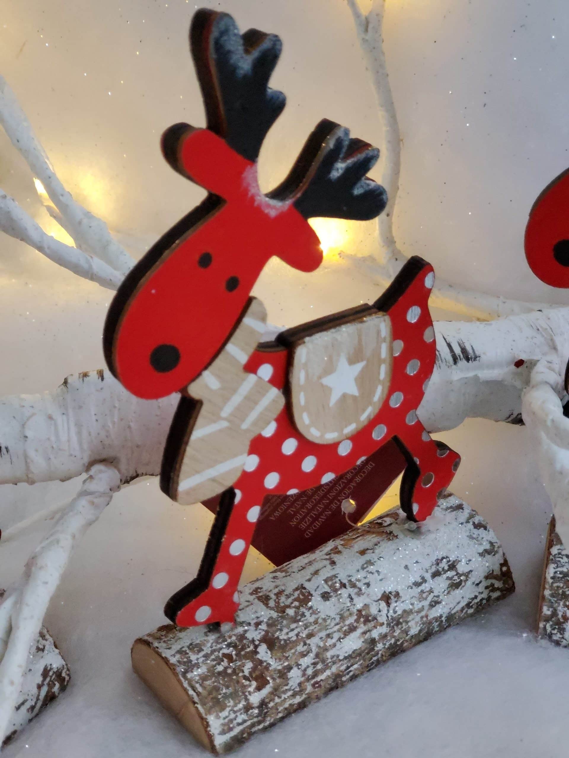 Wooden reindeer on log