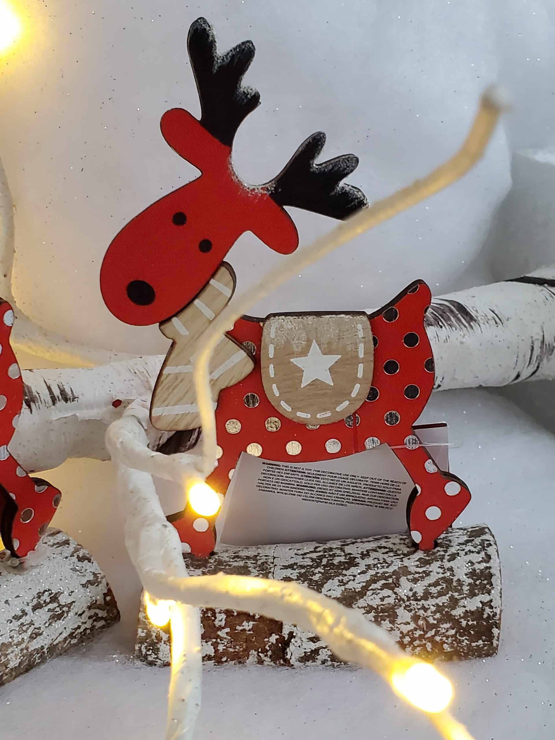 Wooden reindeer on log