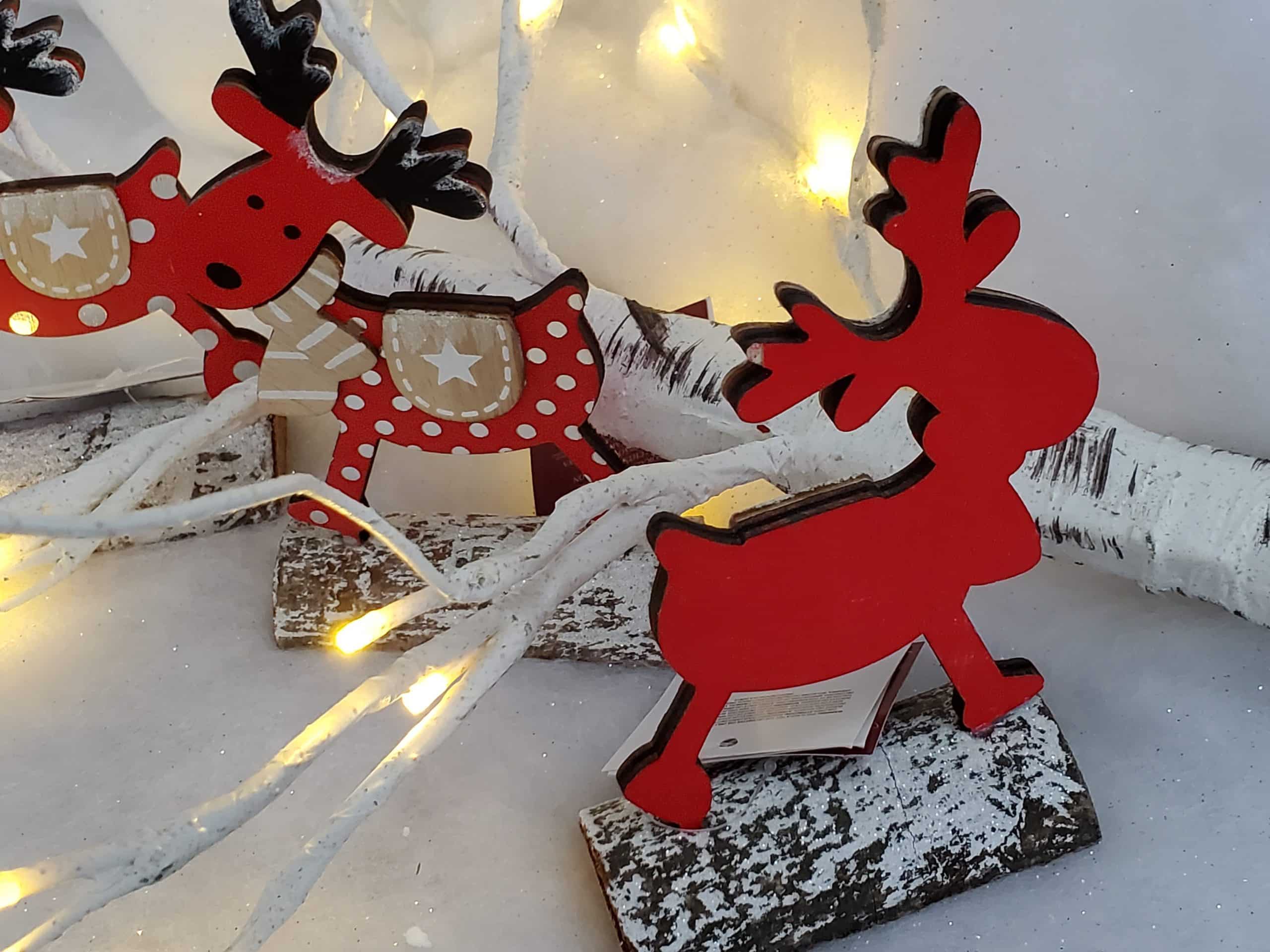 Wooden reindeer on log