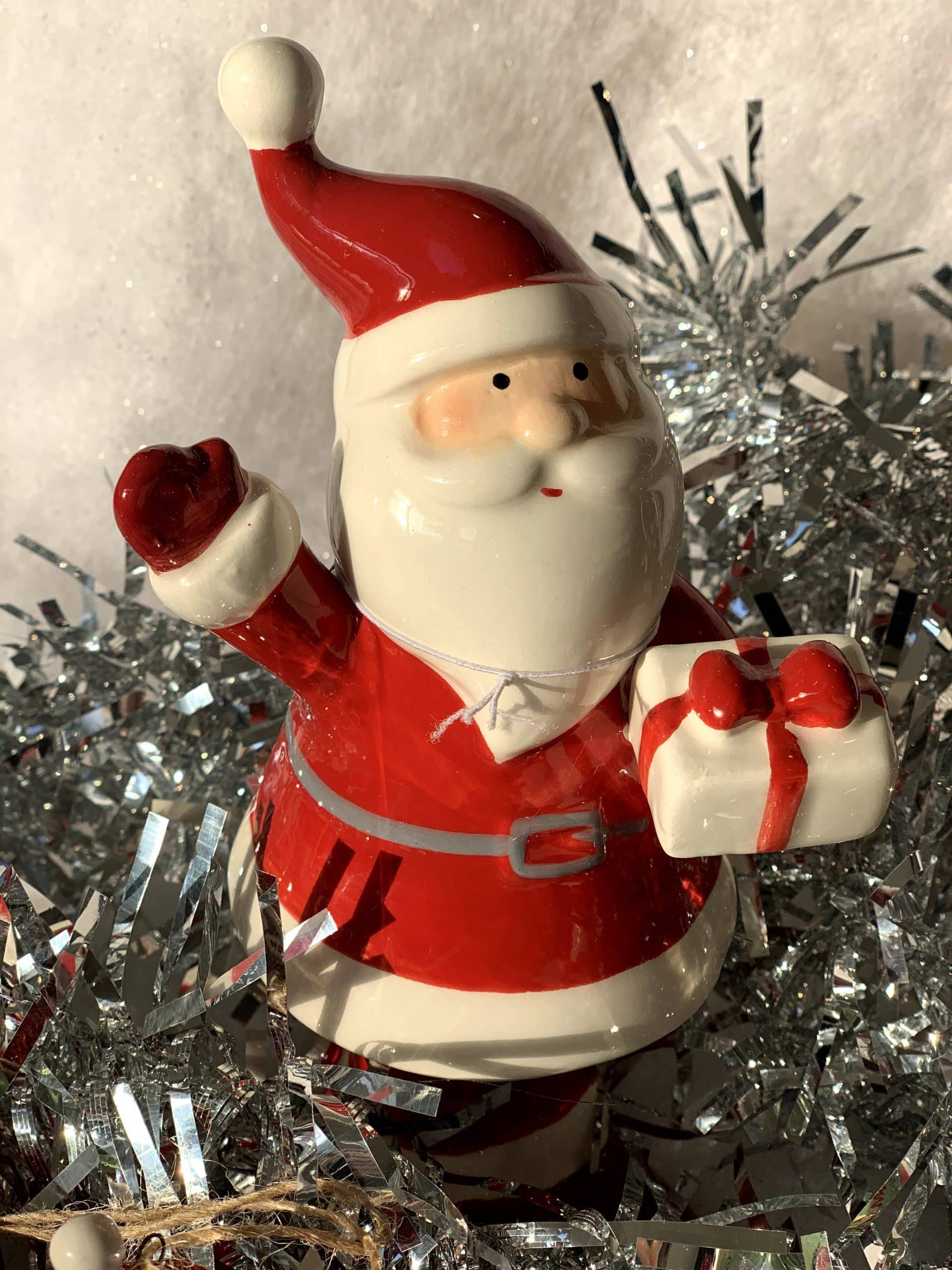 Ceramic Santa holding present